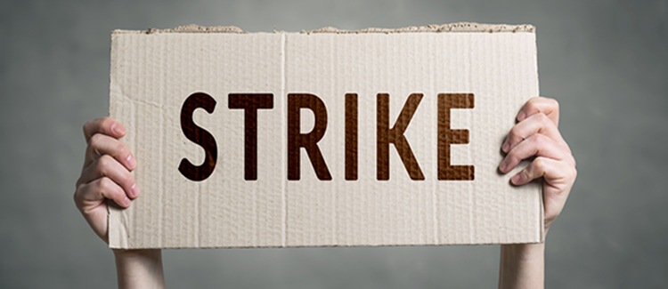 Holding up a strike sign.